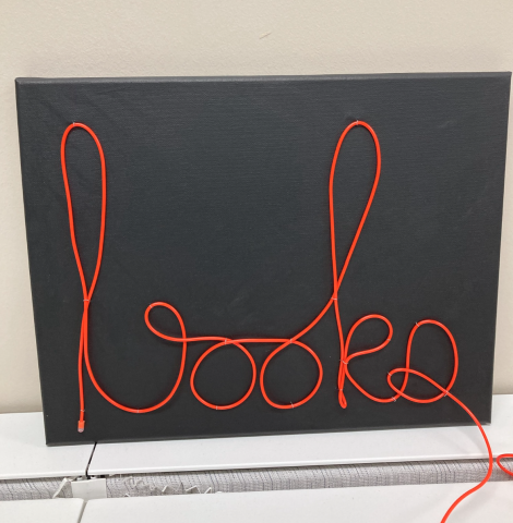 A neon sign spelling out the word 'books'