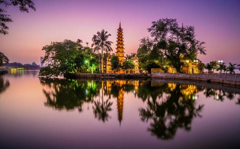 tall tower reflecting on water