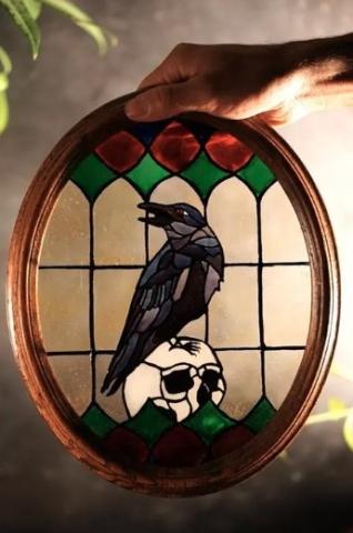 DIY stained glass artwork of a crow and skull