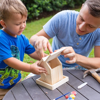 Father and son building a birdhouse together