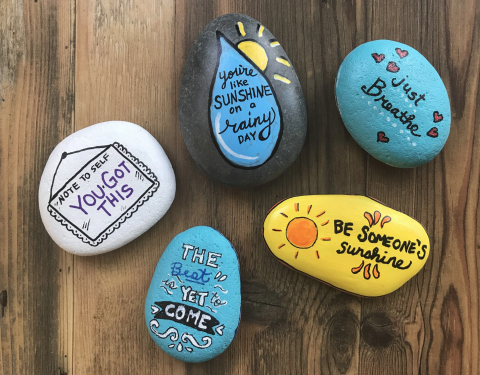 Small rocks painted with positive messages such as "You got this!"