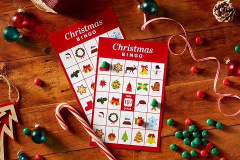 2 bingo cards on a table with Christmas ornaments