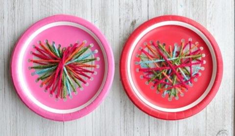 red and pink paper plates with yarn strung in shape of heart in each