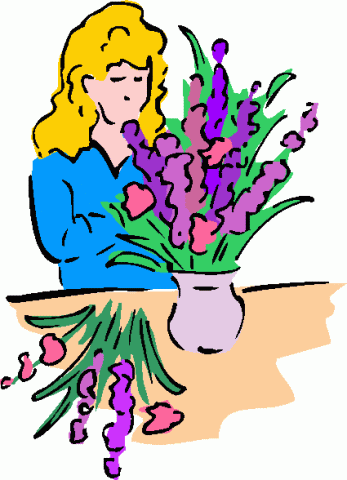 a lady putting flowers into a vase