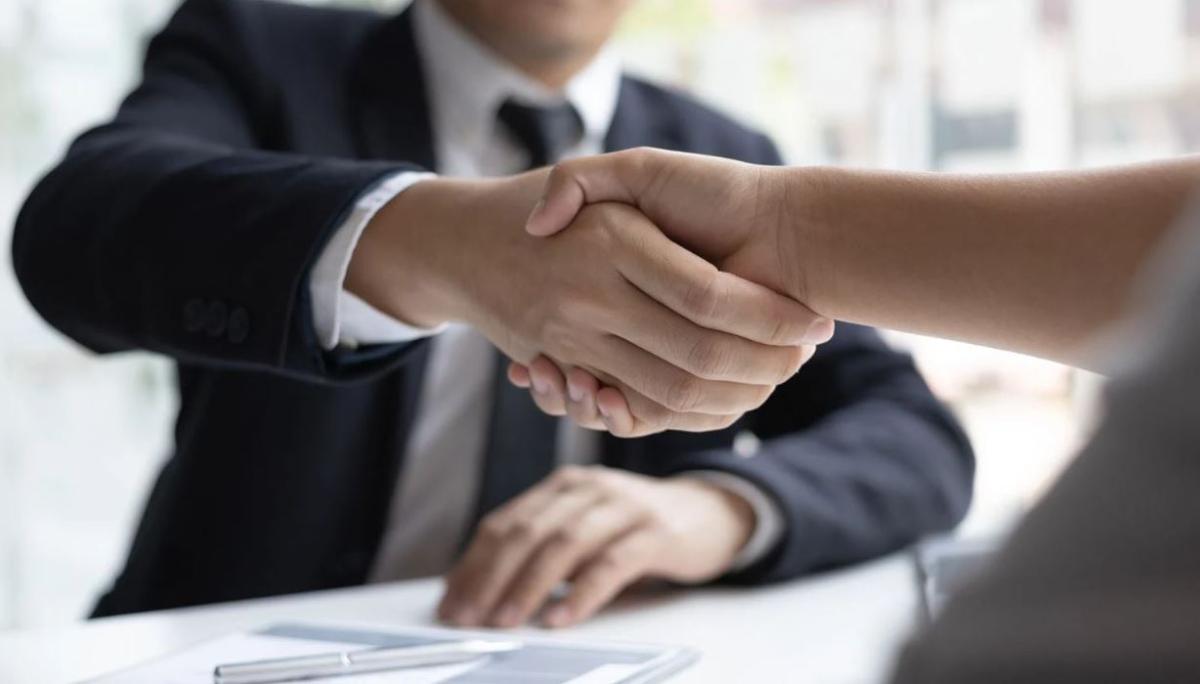 Two people in suits shaking hands