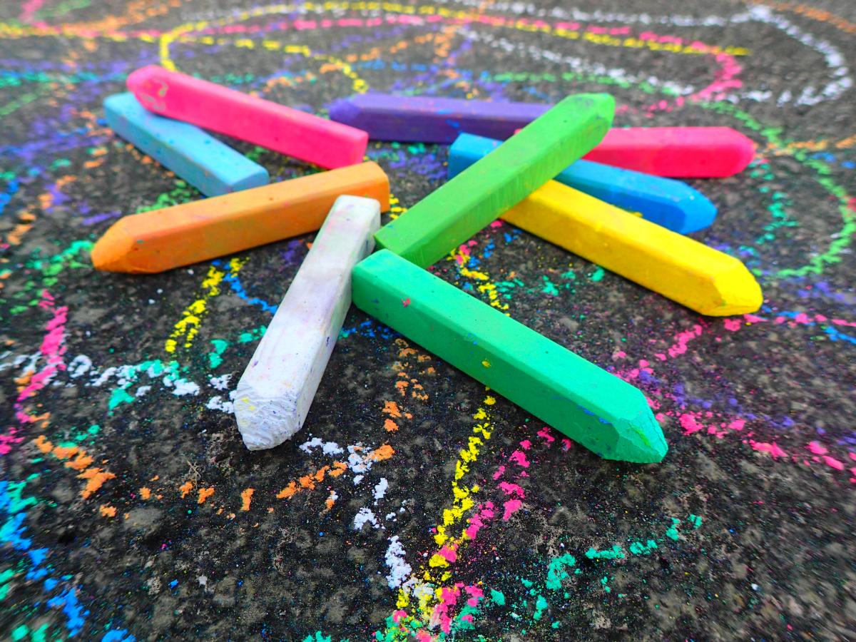 different colors of sidewalk chalk on pavement