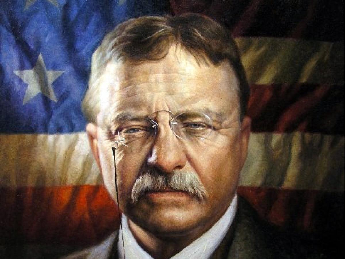 Portrait of Teddy Roosevelt with backdrop of American flag