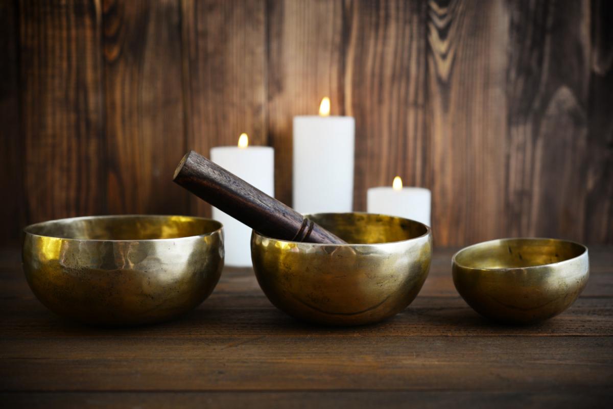 bowls sitting on the ground with white candles in the background