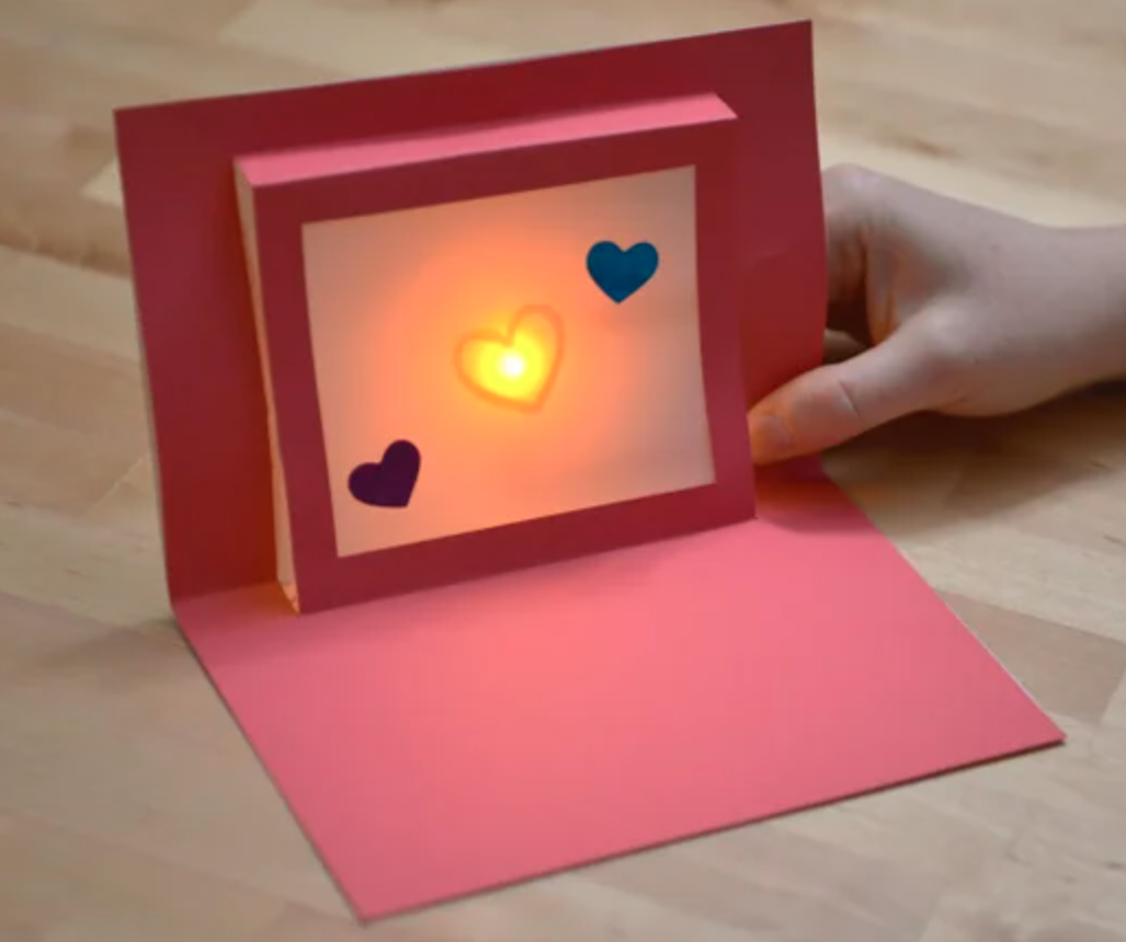 A Valentine's Day card with a glowing heart in the middle